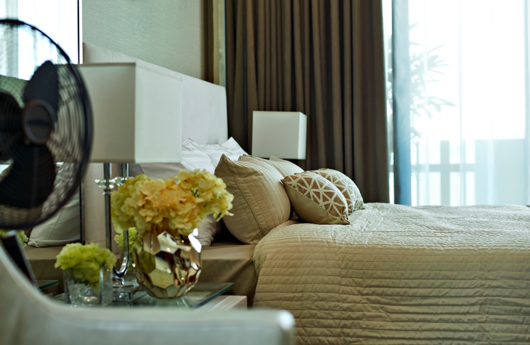 white and yellow flowers on clear glass vase on table