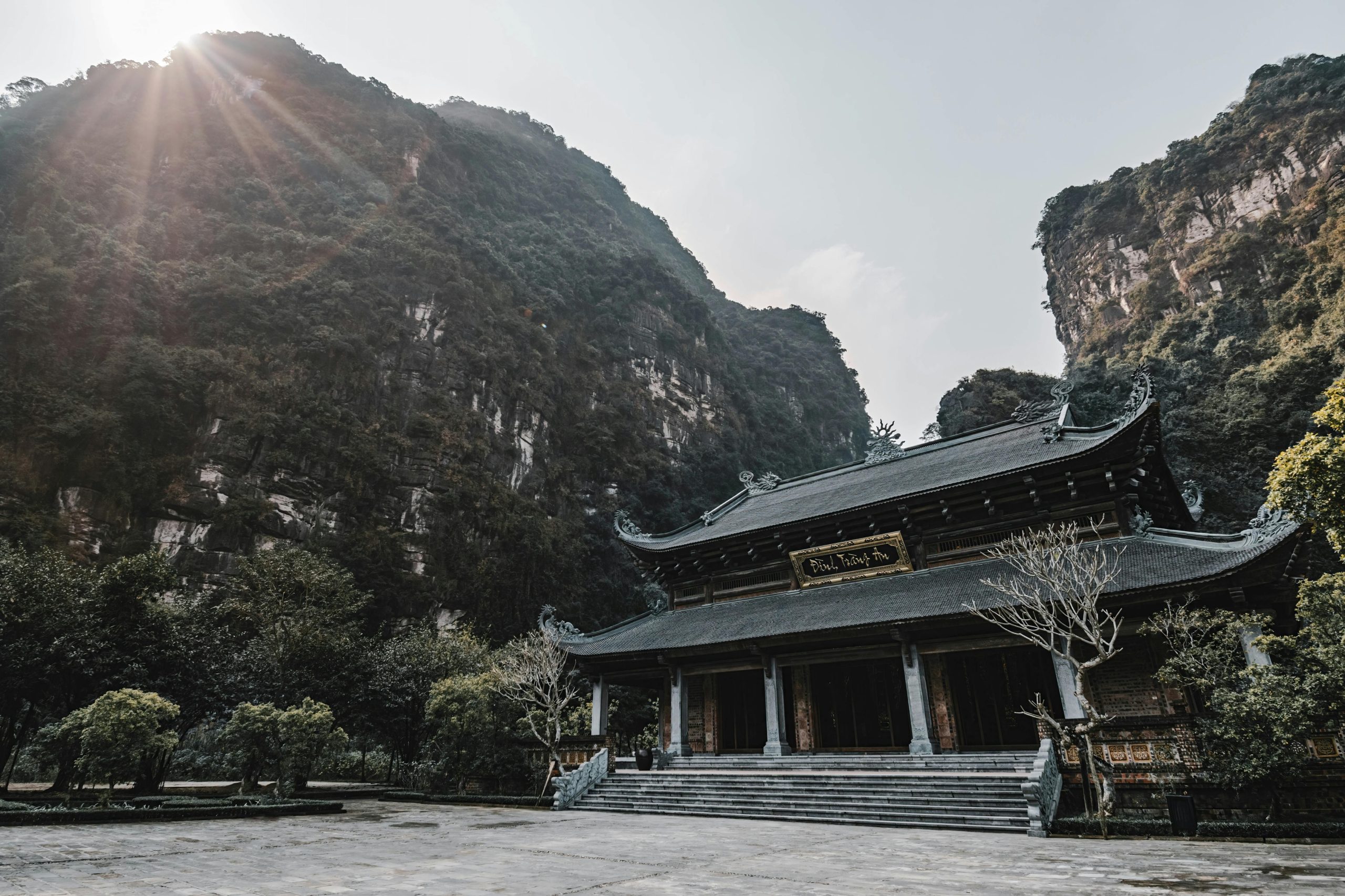 Breathtaking view of a Buddhist temple amidst stunning limestone mountains in Ninh Bình.