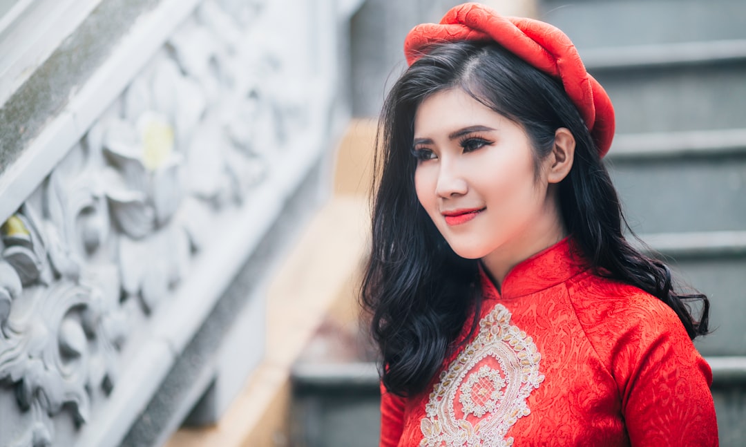 woman wearing red cheongsam top near stair